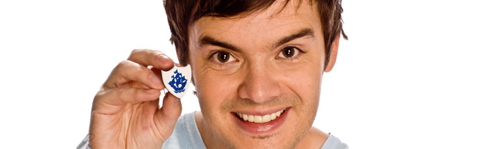 Apply for a Blue Peter Badge Blue Peter presenter Barney Harwood holding a Blue Peter badge