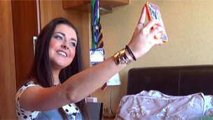 Shannon taking a selfie with her phone.