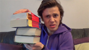 Cel with a stack of books.