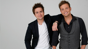 Picture of Sam leaning on Mark and both smiling