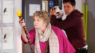 Ursula using her magical staff as Tom watches