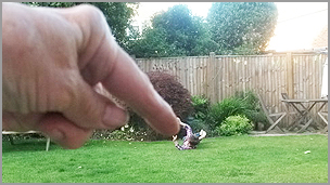 A big hand with a really small boy using a perspective technique
