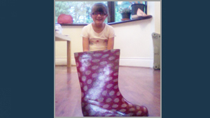 A girl that looks like she's inside a wellington boot