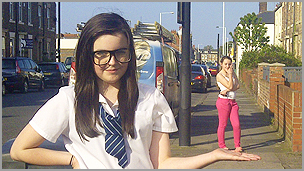 A girl with her hand out to the side with her friend balancing on it, using the perspective technique
